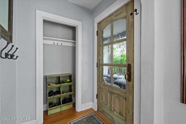 mudroom with wood finished floors and baseboards