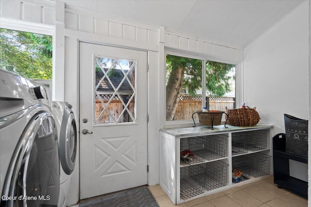 laundry room with laundry area, light tile patterned floors, and independent washer and dryer