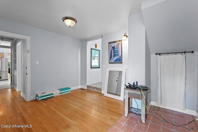 interior space featuring baseboards and wood finished floors