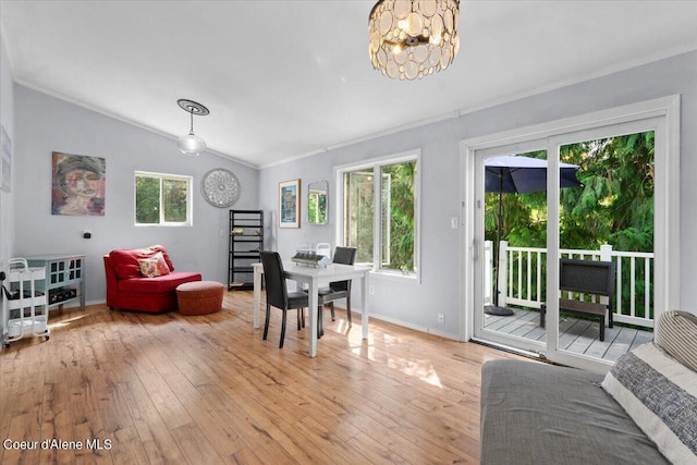 dining space with lofted ceiling, light wood-style floors, and a healthy amount of sunlight