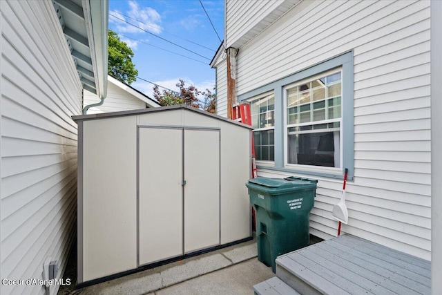 view of patio with a storage shed and an outbuilding