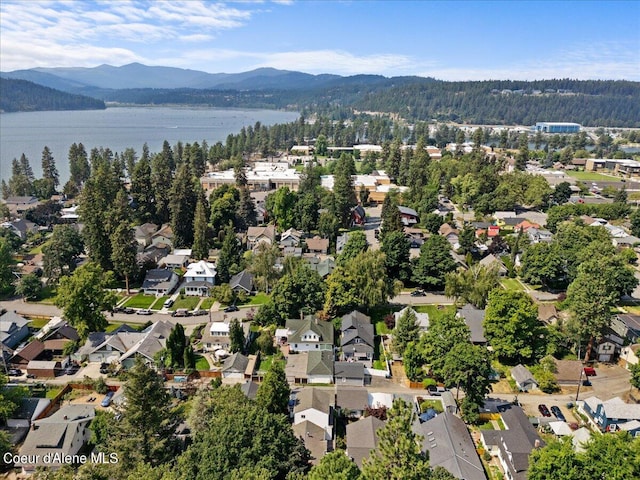 drone / aerial view featuring a residential view and a water and mountain view