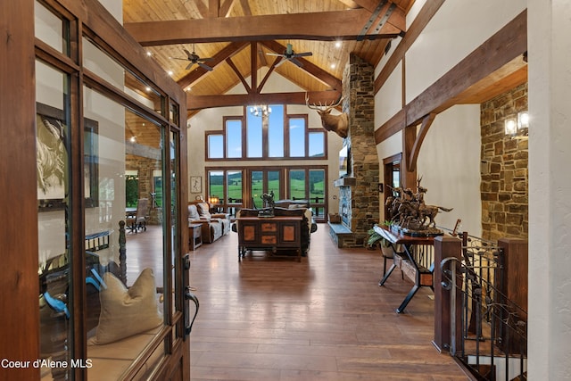 interior space with hardwood / wood-style flooring, high vaulted ceiling, wooden ceiling, beamed ceiling, and ceiling fan with notable chandelier