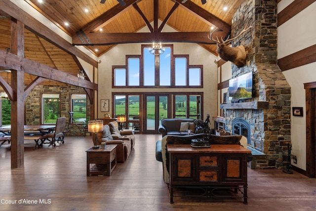 living area with a stone fireplace, hardwood / wood-style flooring, and wood ceiling