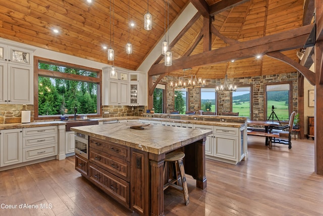 kitchen featuring a peninsula, hardwood / wood-style floors, a center island, and decorative backsplash