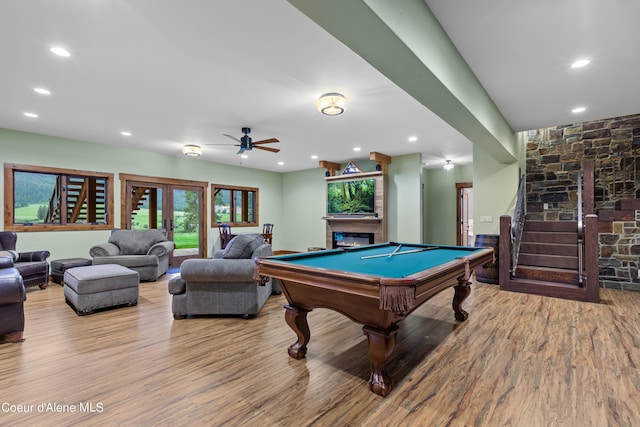 playroom featuring billiards, wood finished floors, a glass covered fireplace, and recessed lighting