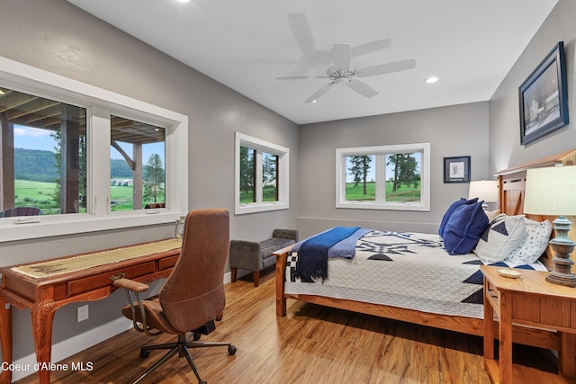 bedroom with a ceiling fan, recessed lighting, baseboards, and wood finished floors