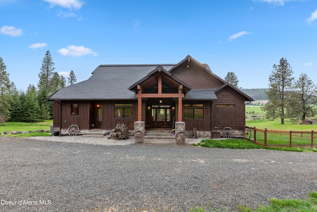 view of front of house with fence and roof with shingles