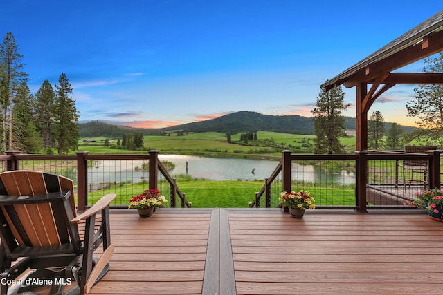 deck with a water and mountain view