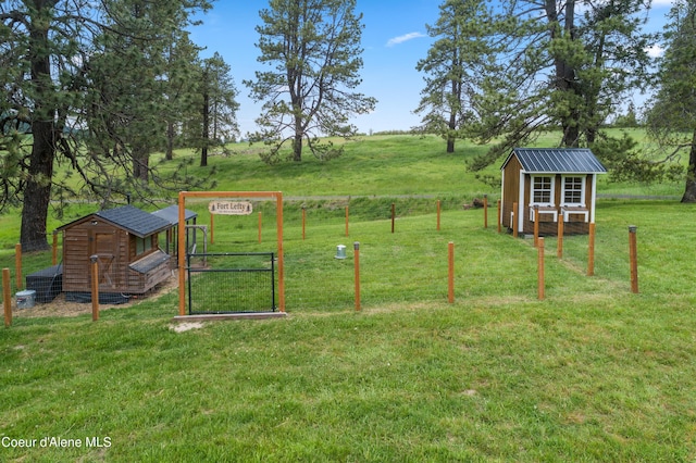 view of jungle gym featuring a lawn, an outdoor structure, and exterior structure