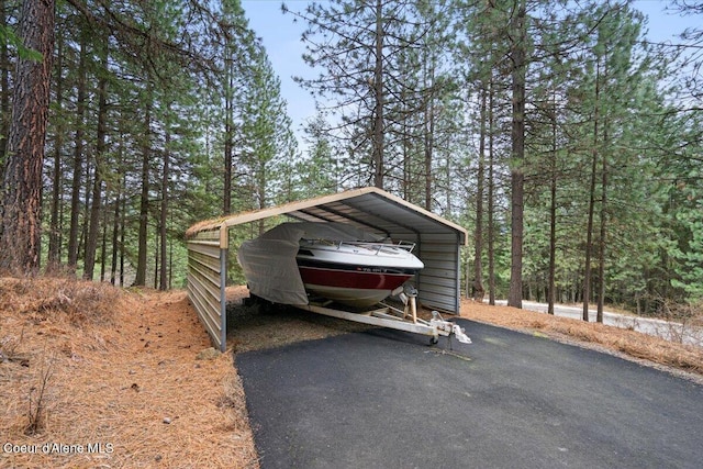 view of car parking with aphalt driveway and a detached carport