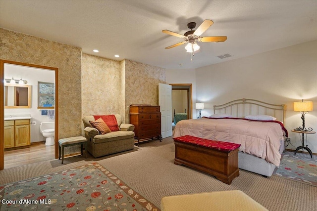 bedroom featuring recessed lighting, ceiling fan, visible vents, and ensuite bathroom