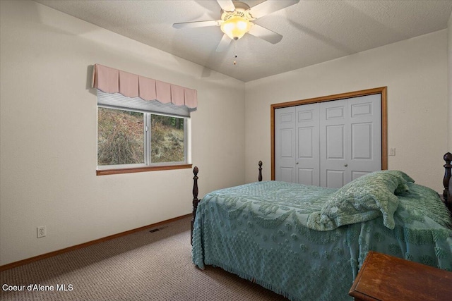 carpeted bedroom with baseboards, a textured ceiling, visible vents, and a closet