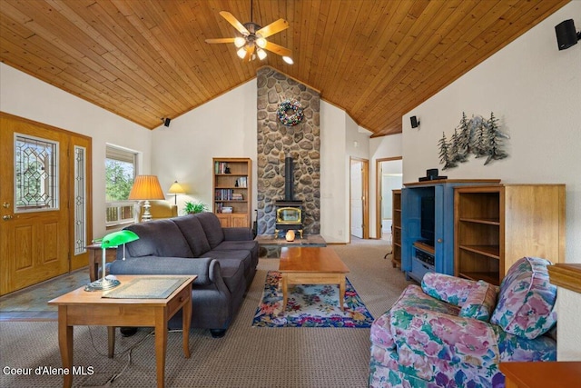 carpeted living area featuring high vaulted ceiling, wood ceiling, a wood stove, and a ceiling fan