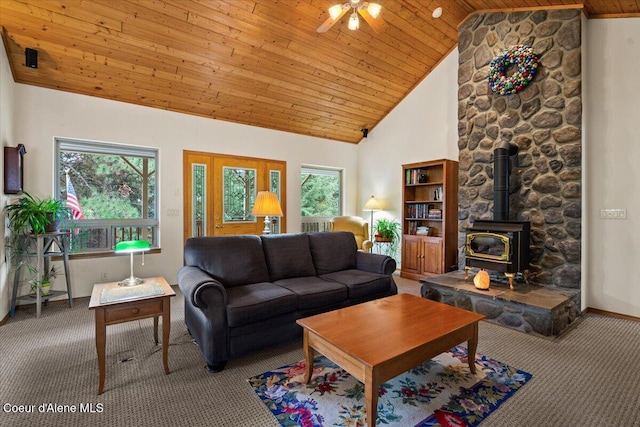 living area featuring carpet floors, wooden ceiling, high vaulted ceiling, and a wood stove