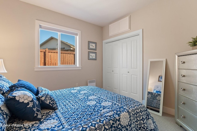 carpeted bedroom featuring visible vents, baseboards, and a closet