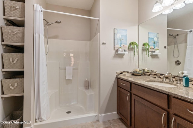 full bathroom with curtained shower, baseboards, and vanity