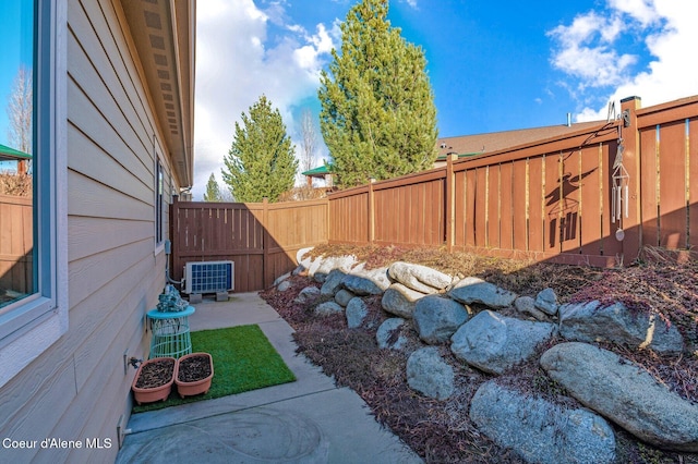 view of yard featuring a patio, central air condition unit, and a fenced backyard