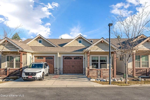 view of front facade featuring a shingled roof, a porch, concrete driveway, stone siding, and an attached garage