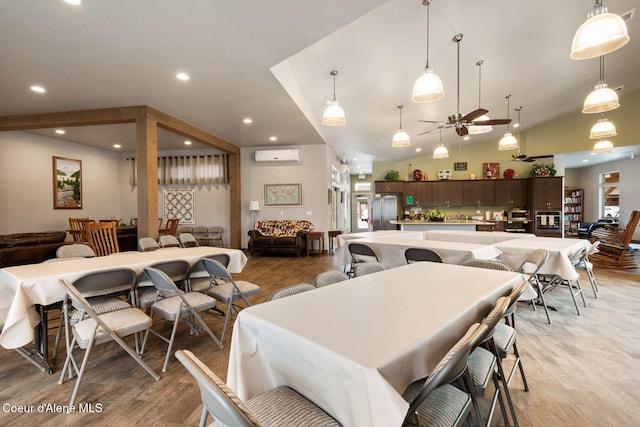 dining space featuring high vaulted ceiling, a wall mounted AC, recessed lighting, light wood finished floors, and ceiling fan