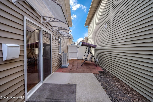 view of patio featuring central AC unit and a gate