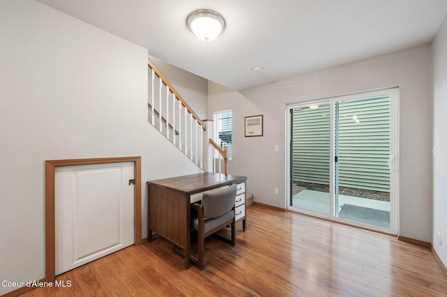 home office featuring baseboards and light wood-style flooring