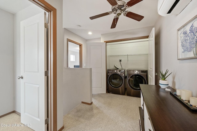 laundry area featuring laundry area, washing machine and dryer, baseboards, and a wall mounted AC