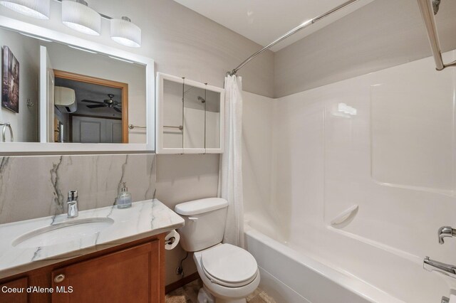 bathroom featuring vanity, toilet, and shower / tub combo with curtain