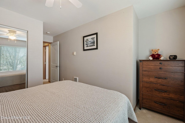 bedroom with a ceiling fan, light colored carpet, and visible vents