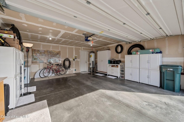 garage featuring a garage door opener and water heater