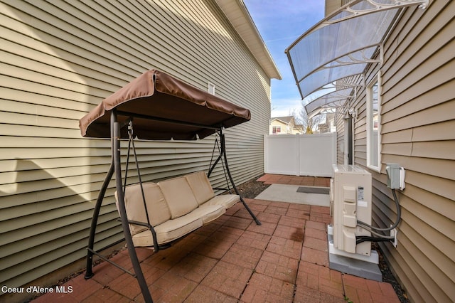 view of patio / terrace featuring ac unit and fence