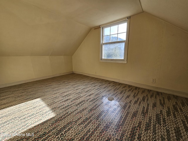 bonus room featuring baseboards and vaulted ceiling