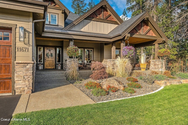 doorway to property with board and batten siding and a porch