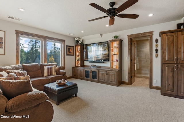 living area with recessed lighting, visible vents, light carpet, a textured ceiling, and baseboards