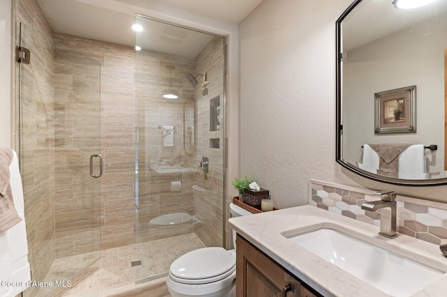 full bathroom with tasteful backsplash, a textured wall, toilet, a stall shower, and vanity