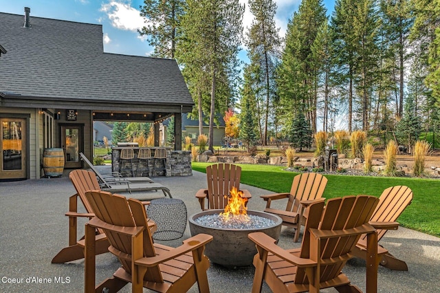 view of patio featuring outdoor dry bar and an outdoor fire pit