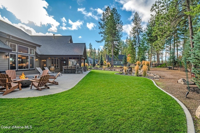 view of yard featuring a patio and a fire pit