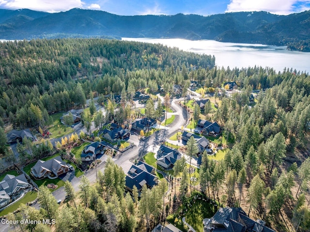 bird's eye view with a residential view, a wooded view, and a water and mountain view