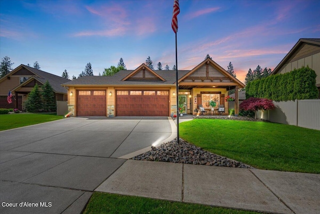 6489 E Kyong, Post Falls, ID 83854 - view of front of home featuring a garage, concrete driveway, and stone siding