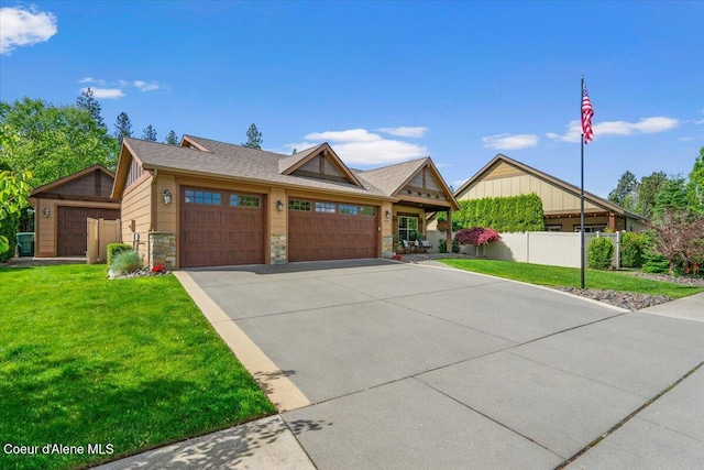 6489 E Kyong, Post Falls, ID 83854 - view of front of property with a garage, concrete driveway, stone siding, and board and batten siding