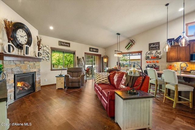 6489 E Kyong, Post Falls, ID 83854 - living room featuring dark wood-style flooring, lofted ceiling, a fireplace, and recessed lighting