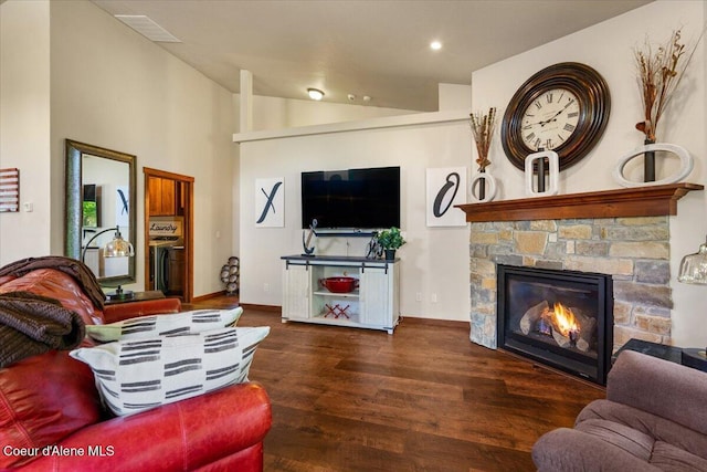 6489 E Kyong, Post Falls, ID 83854 - living room with wood finished floors, vaulted ceiling, a stone fireplace, baseboards, and recessed lighting