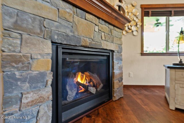 6489 E Kyong, Post Falls, ID 83854 - detailed view of a stone fireplace, wood finished floors, and baseboards
