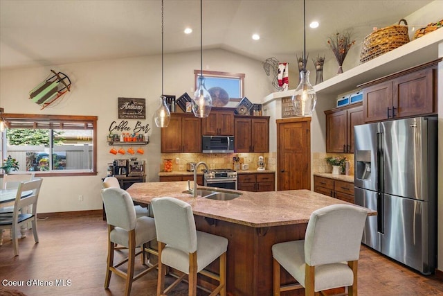 6489 E Kyong, Post Falls, ID 83854 - kitchen with stainless steel appliances, a sink, healthy amount of natural light, a breakfast bar, and recessed lighting