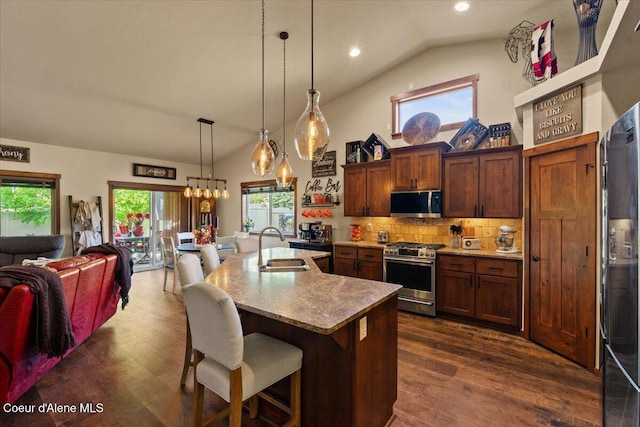 6489 E Kyong, Post Falls, ID 83854 - kitchen featuring stainless steel appliances, a sink, open floor plan, a kitchen breakfast bar, and dark wood finished floors