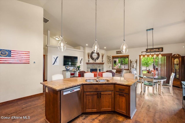6489 E Kyong, Post Falls, ID 83854 - kitchen featuring dishwasher, a fireplace, open floor plan, hanging light fixtures, and dark wood-style floors