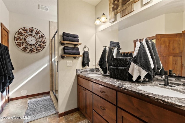 6489 E Kyong, Post Falls, ID 83854 - full bathroom featuring baseboards, double vanity, and a stall shower
