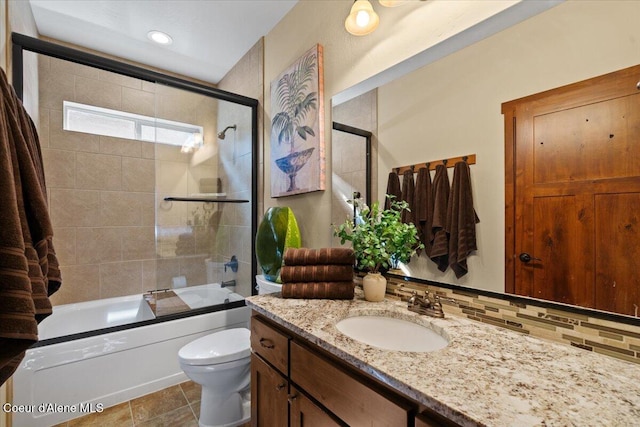 6489 E Kyong, Post Falls, ID 83854 - bathroom with vanity, combined bath / shower with glass door, backsplash, and toilet