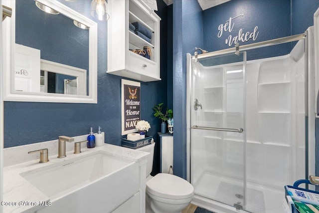 6489 E Kyong, Post Falls, ID 83854 - bathroom with a textured wall, a shower stall, toilet, and vanity