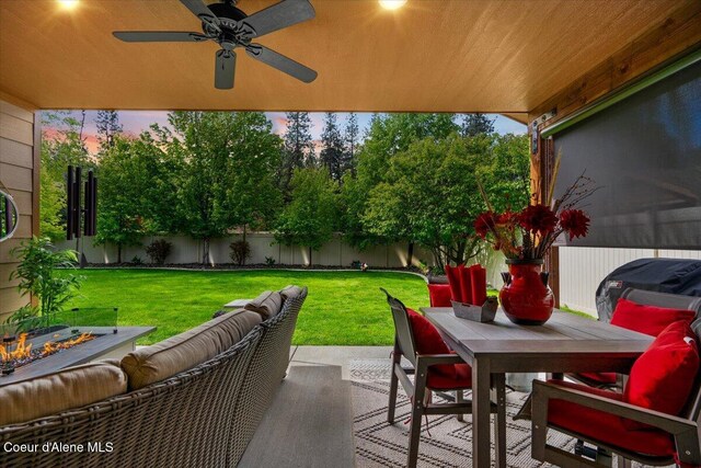 6489 E Kyong, Post Falls, ID 83854 - patio terrace at dusk featuring outdoor dining area, an outdoor hangout area, a patio area, and a ceiling fan
